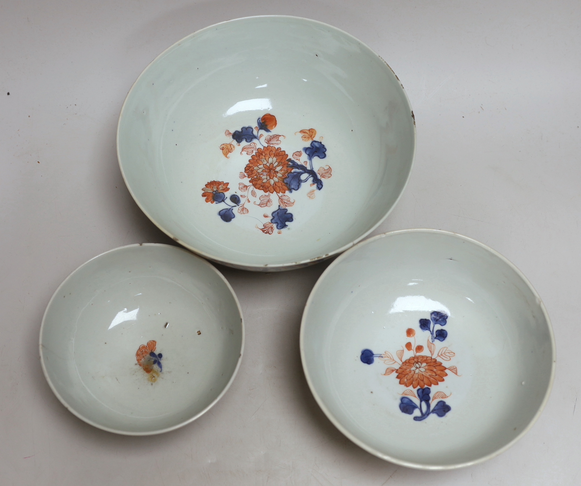 A graduated set of three Chinese Imari bowls, Qianlong period, hand painted with flowers, the largest 23cm in diameter